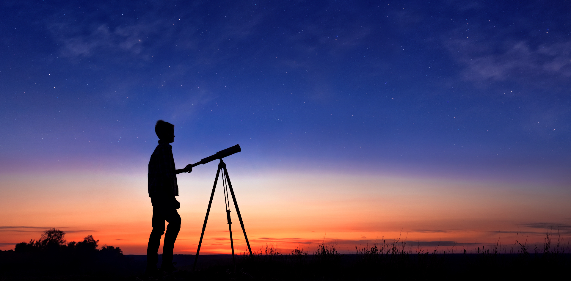 Young people silhouetted against Earth and cosmos